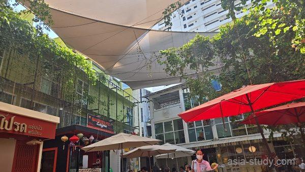 Ari（アーリー）周辺の屋外フードコート、ツタと日よけ布のある中庭