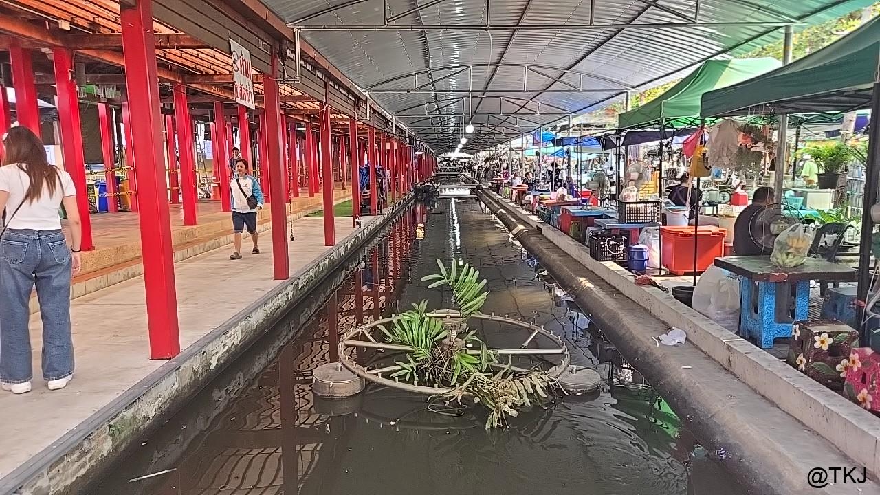 屋根付きの水上マーケット通路、細い運河の両側に屋台が並ぶ市場の内部