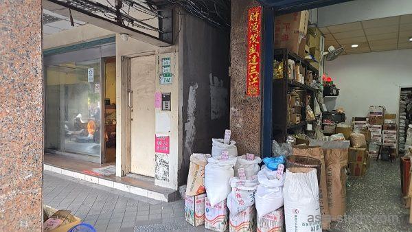 龍山寺近くの路地にある乾物店の入口（袋入り穀物や食材が並ぶ店頭）